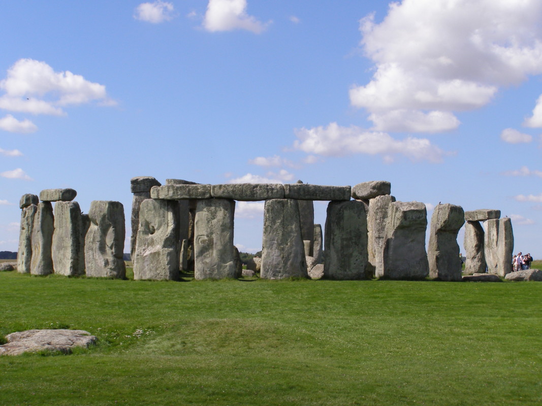 “Stonehenge with blue sky and green land in England”