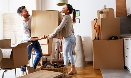 A-man-and-a-woman-carrying-boxes-inside-a-house